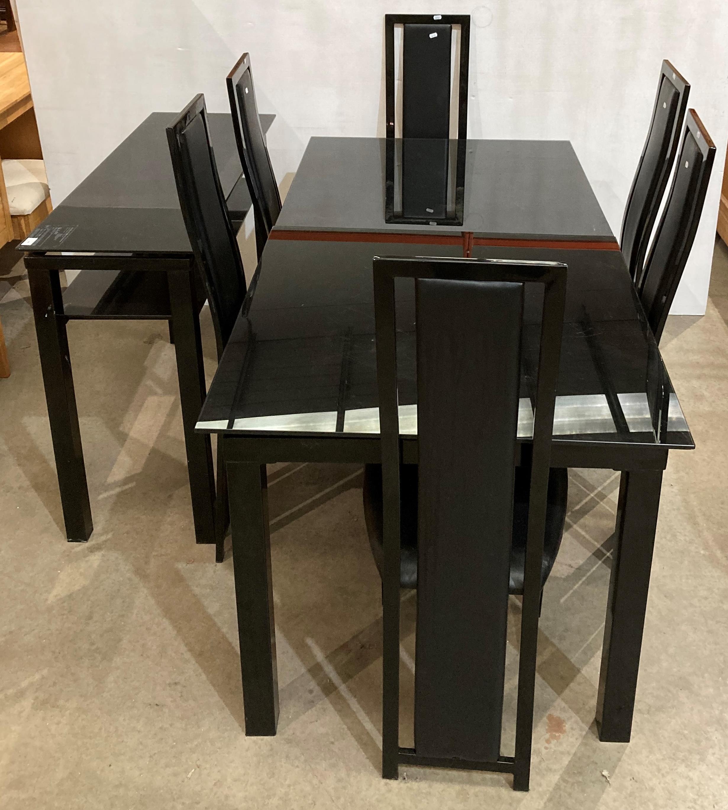 Black glass extending dining table with six matching black high-back dining chairs and a matching