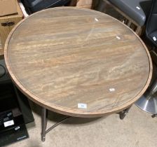 A metal framed wood topped table with glass insert,
