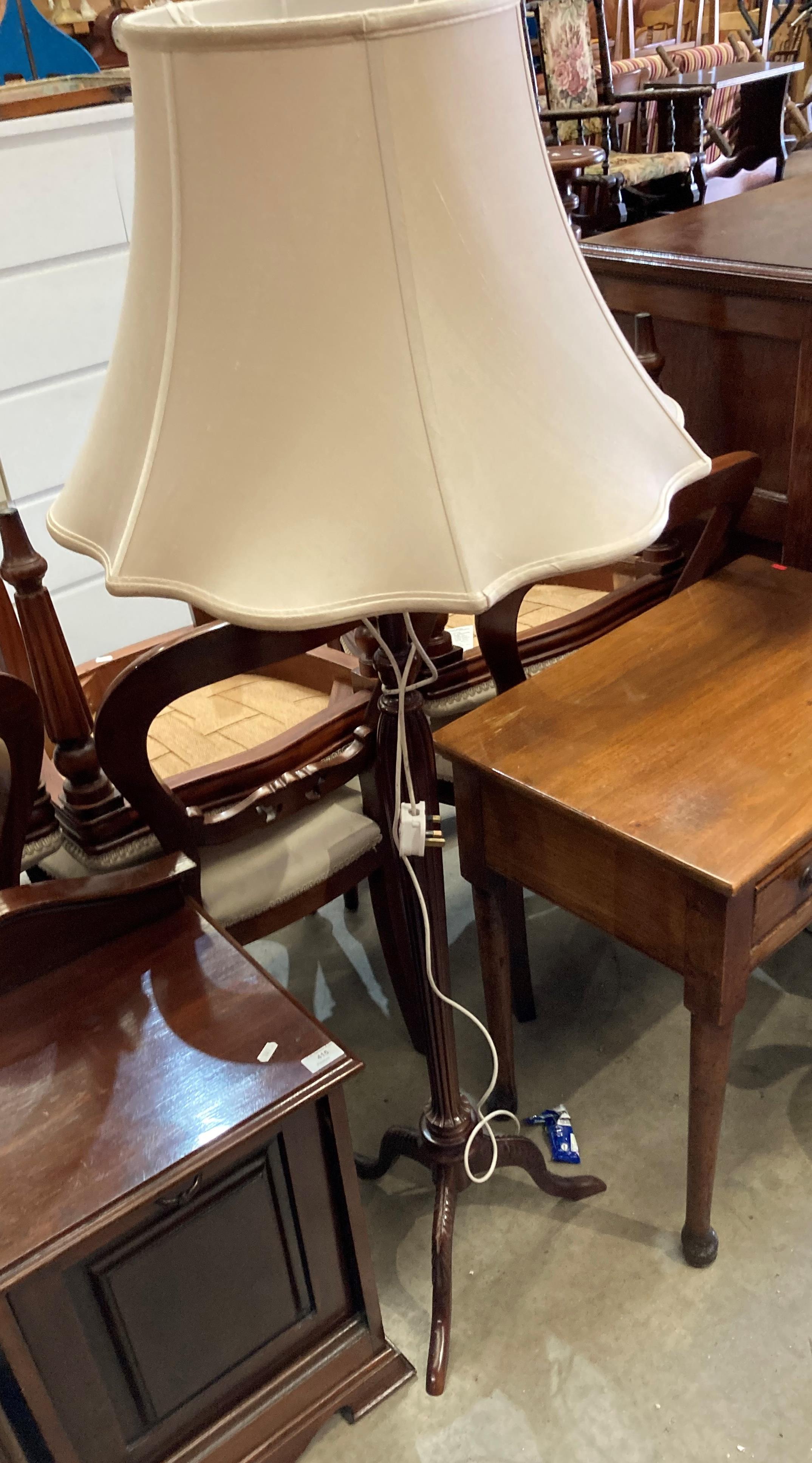 A mahogany standard lamp with ivory coloured shade (saleroom location: MA2)