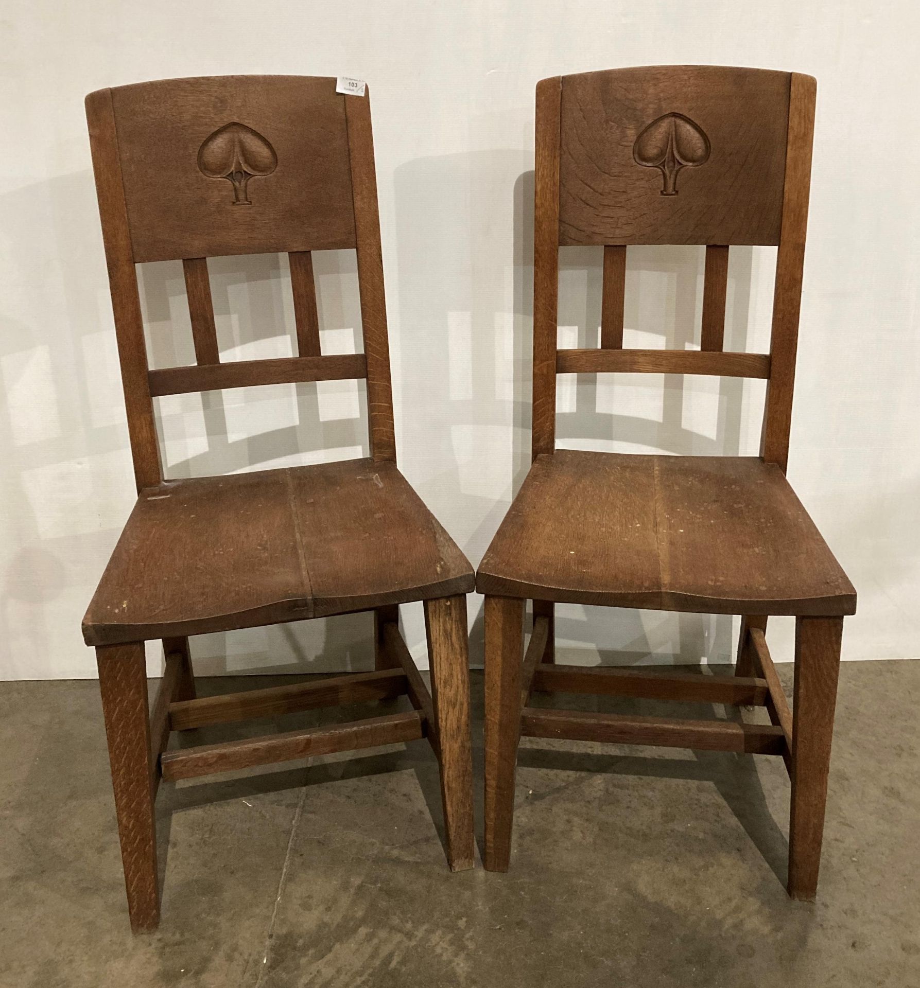 A pair of Arts & Crafts oak chairs designed by William James Neatby (1860-1910) with hand-carved