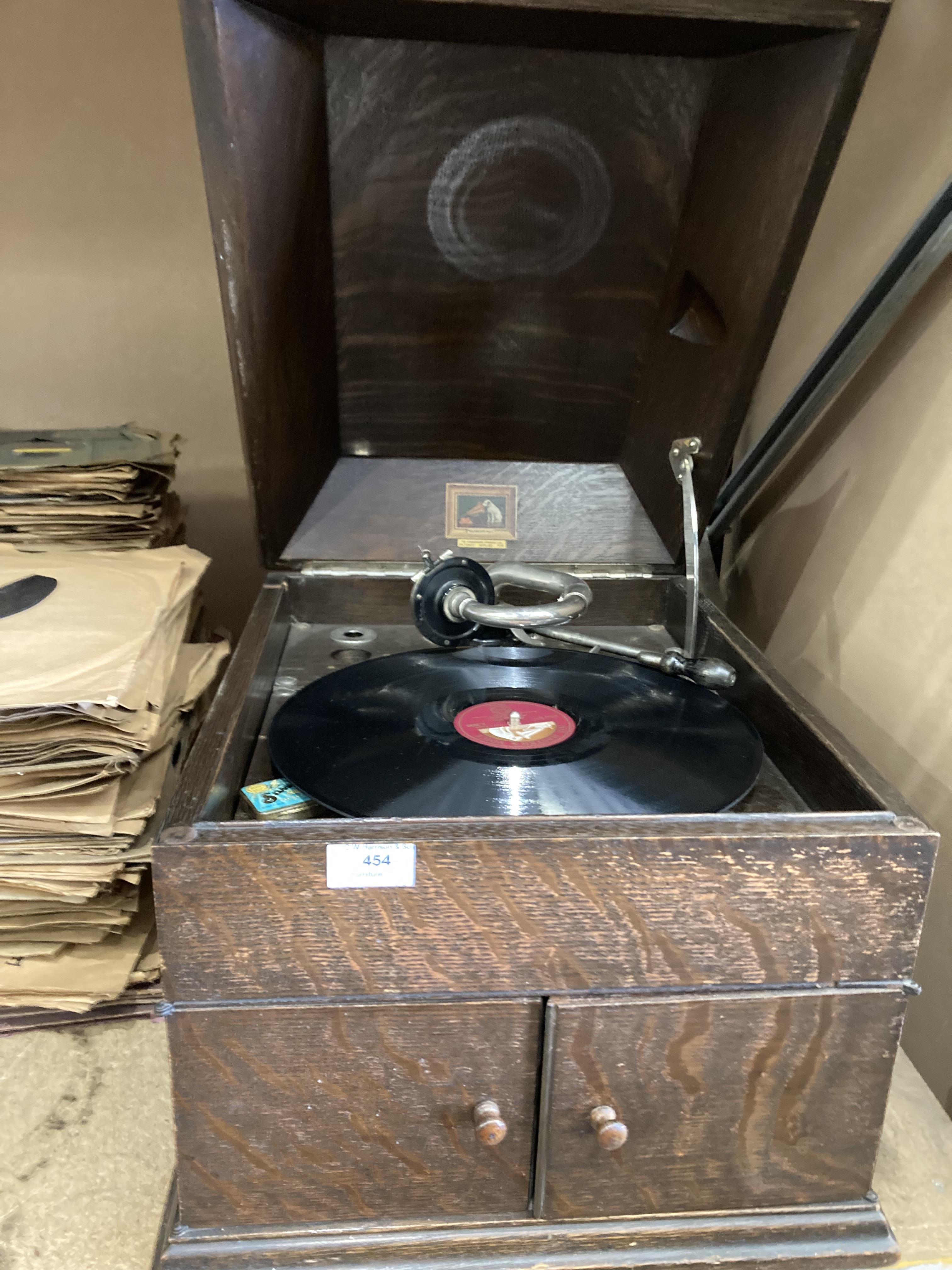 A His Masters Voice table top gramophone in oak case and two large stacks of 78rpm records