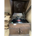 A His Masters Voice table top gramophone in oak case and two large stacks of 78rpm records