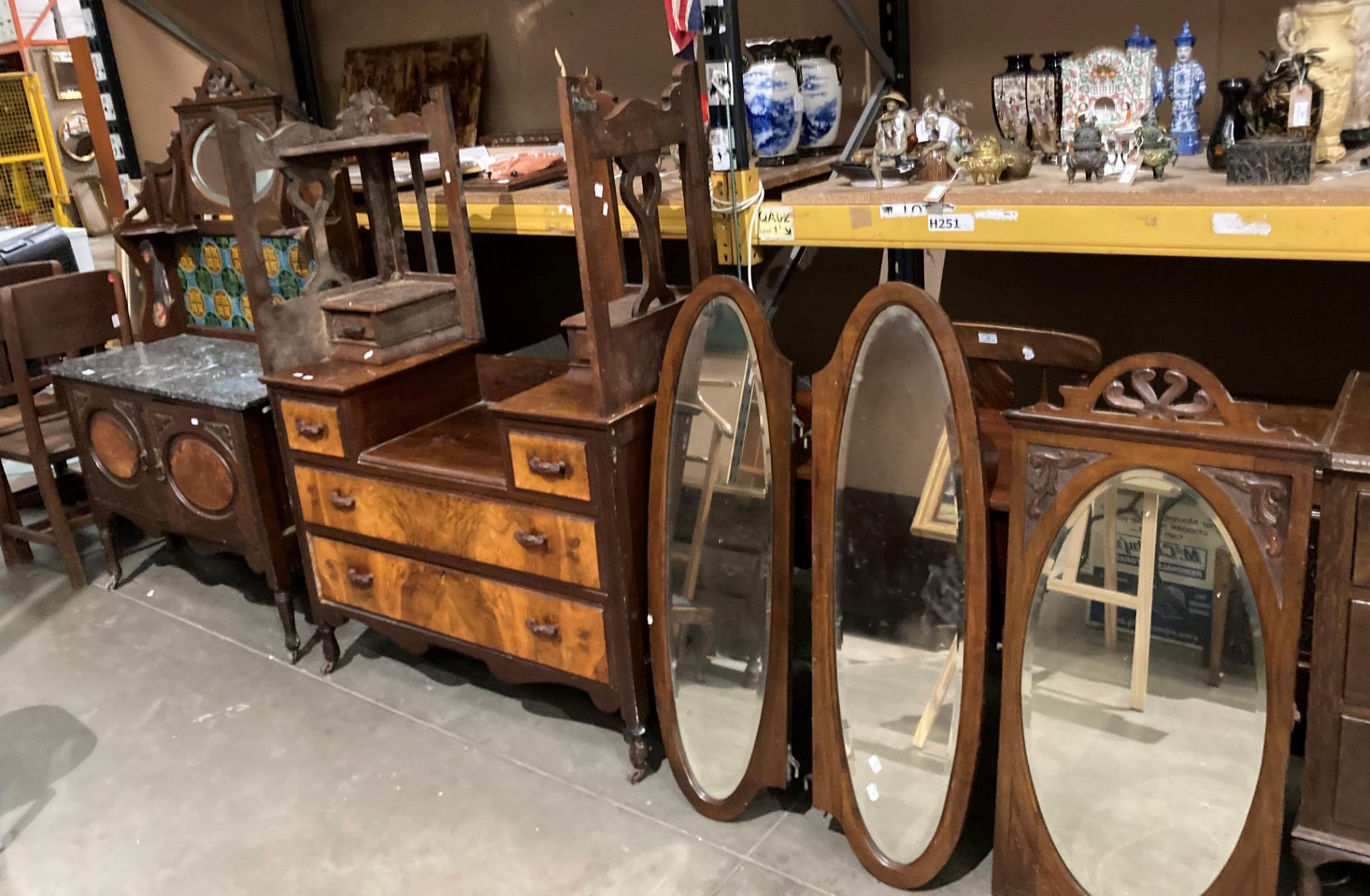 An early 20th century mahogany and walnut two piece bedroom suite comprising a tiled and mirror