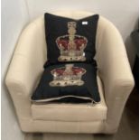 A Marks & Spencers white leather tub armchair and a pair of crown embroidered pillows (saleroom