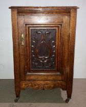 Mid-Century oak single-door cupboard with carved panel,