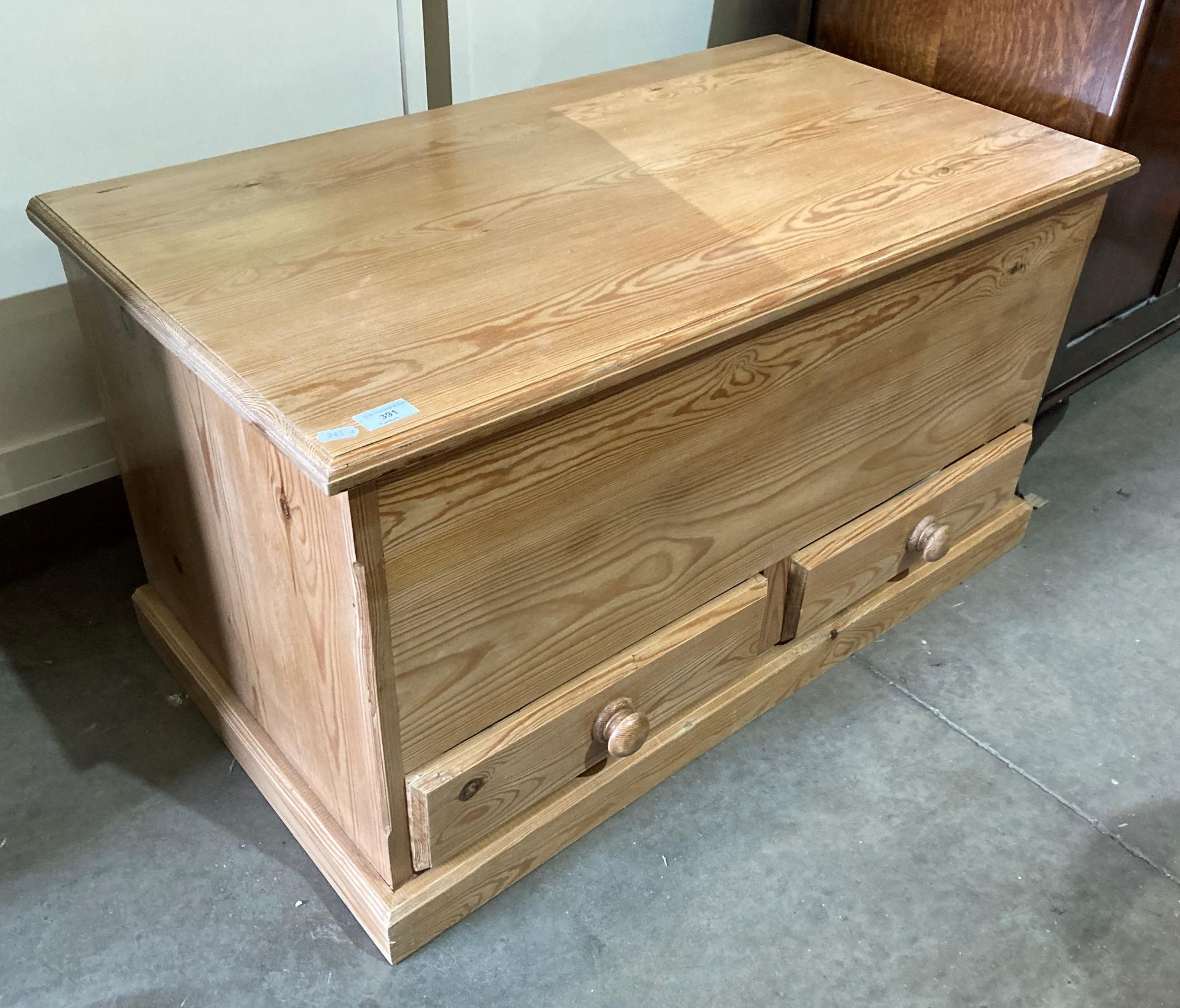 A pine blanket box with two under-drawers,