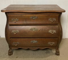 Oak bowed-front three-drawer chest of drawers on hoofed feet,