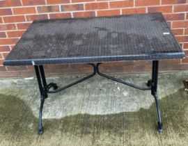 A metal framed garden table with woven effect top,