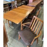 A teak extending dining table together with five G-Plan dining chairs (one carver),