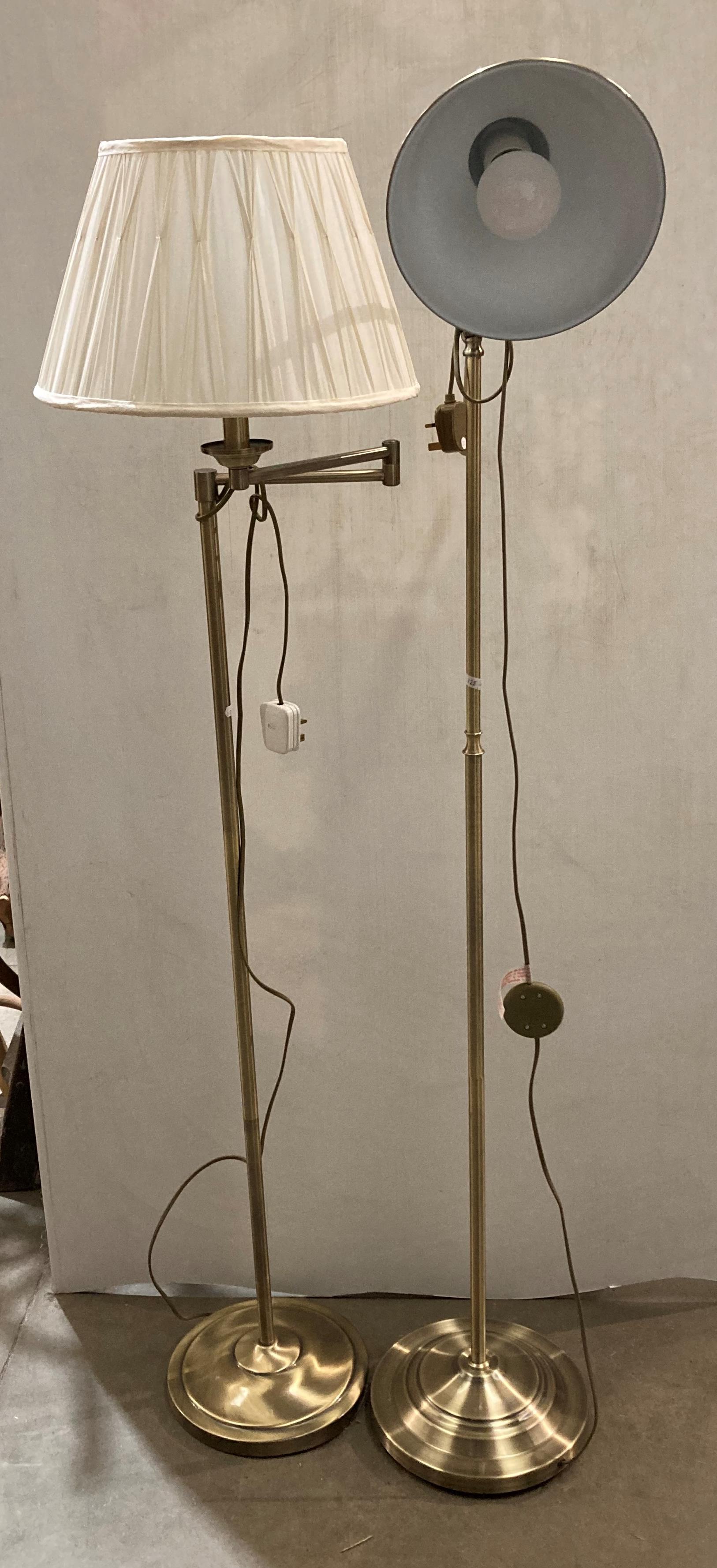 Two brushed brass-effect standing lamps with adjustable heads (saleroom location: MA4)