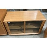 An Ercol blond elm top glazed door entertainment stand,