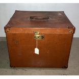 A brown leather-finish luggage case with wood and metal runners to base with initials AAM to side