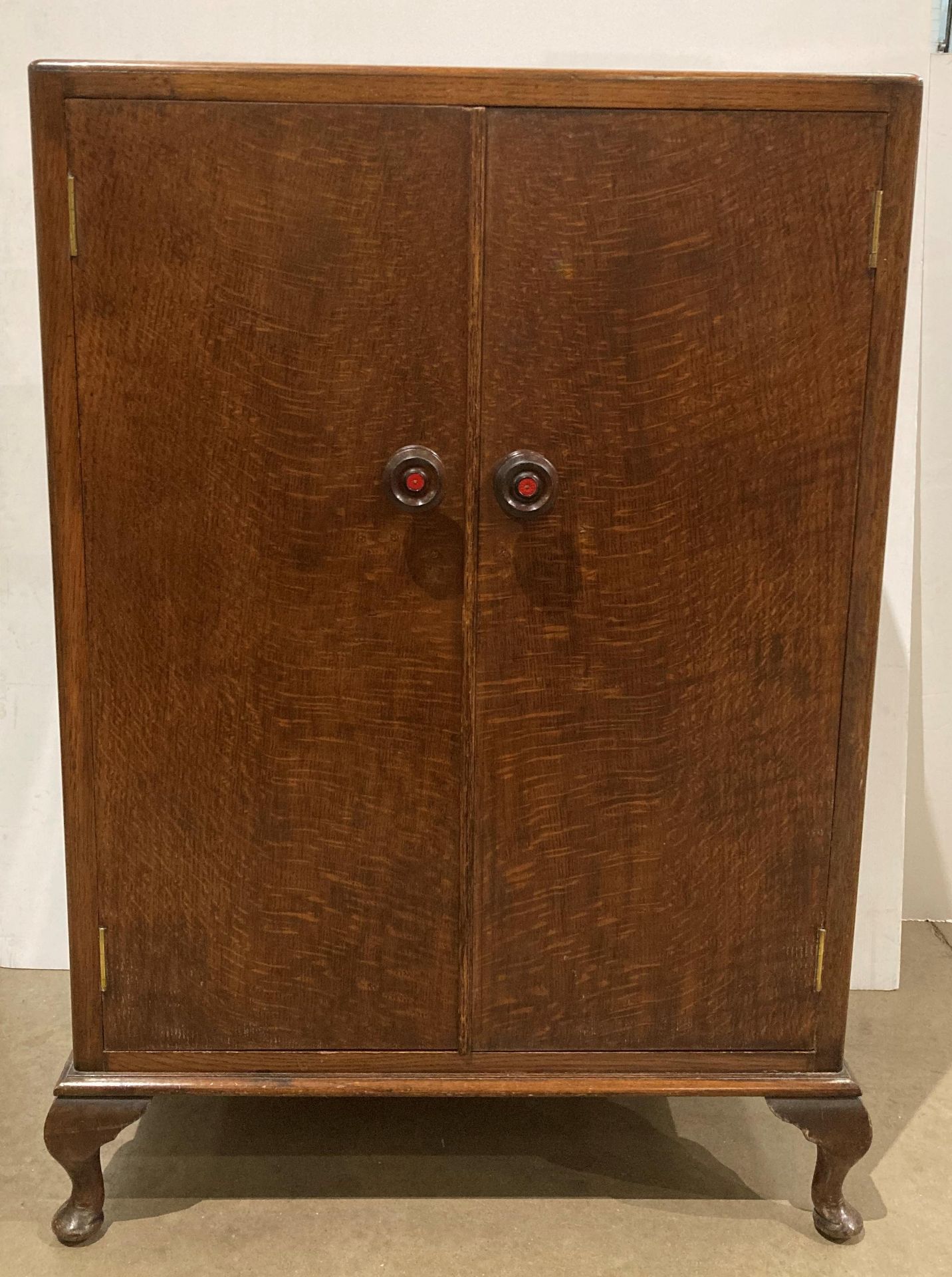 Oak two door storage cabinet on cabriole legs,