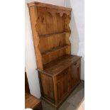 A stripped pine Welsh farmhouse dresser with two drawers and two doors to base section and two