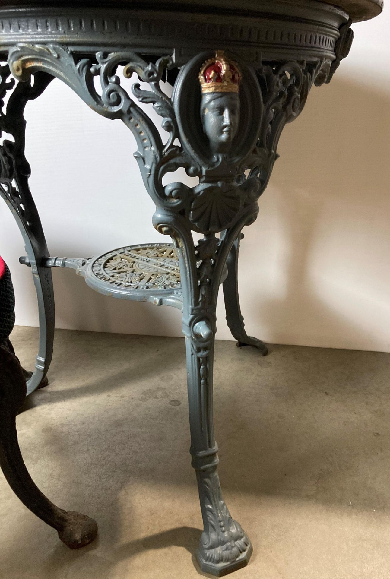 A vintage cast iron pub table with copper covered top and under-shelf with inscription reading - Image 3 of 5