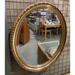 An oval gilt framed mirror,