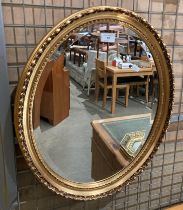 An oval gilt framed mirror,