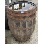 An aged oak whisky/sherry barrel with metal banding,