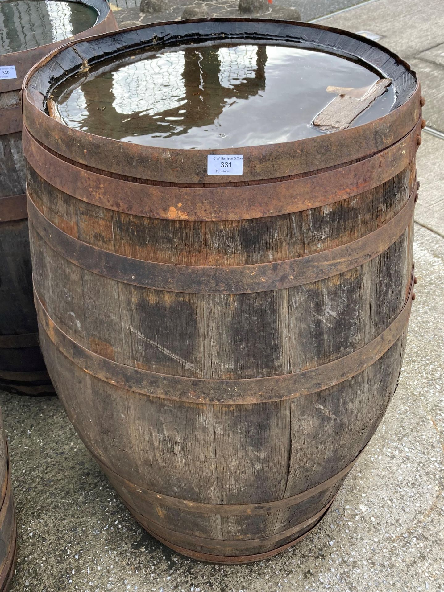 An aged oak whisky/sherry barrel with metal banding,