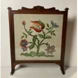 Mahogany framed embroidered fire screen with glass front,