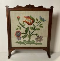 Mahogany framed embroidered fire screen with glass front,