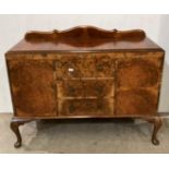 A 20th Century burr walnut two door, three drawer sideboard on cabriole legs,