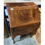 A walnut fall-front bureau with two drawers on cabriole legs,