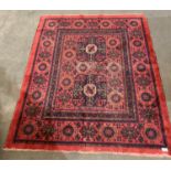 A Persian red/dark blue and brown patterned rug,