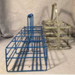 A metal six-slot milk bottle carrier and a metal and blue plastic twelve-bottle carrier (saleroom