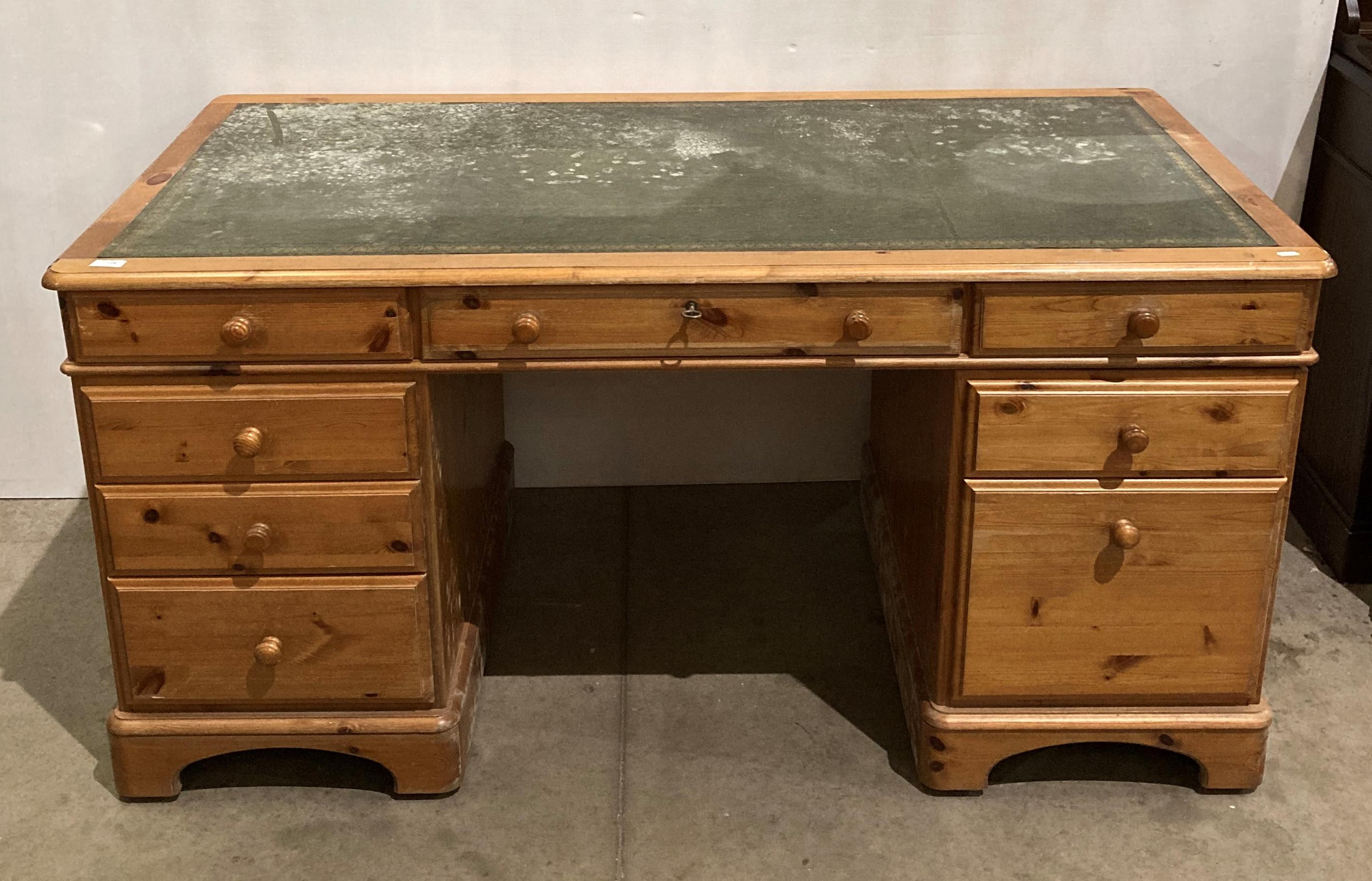 A Ducal pine twin pedestal desk with green tooled leather top insert and eight drawers,