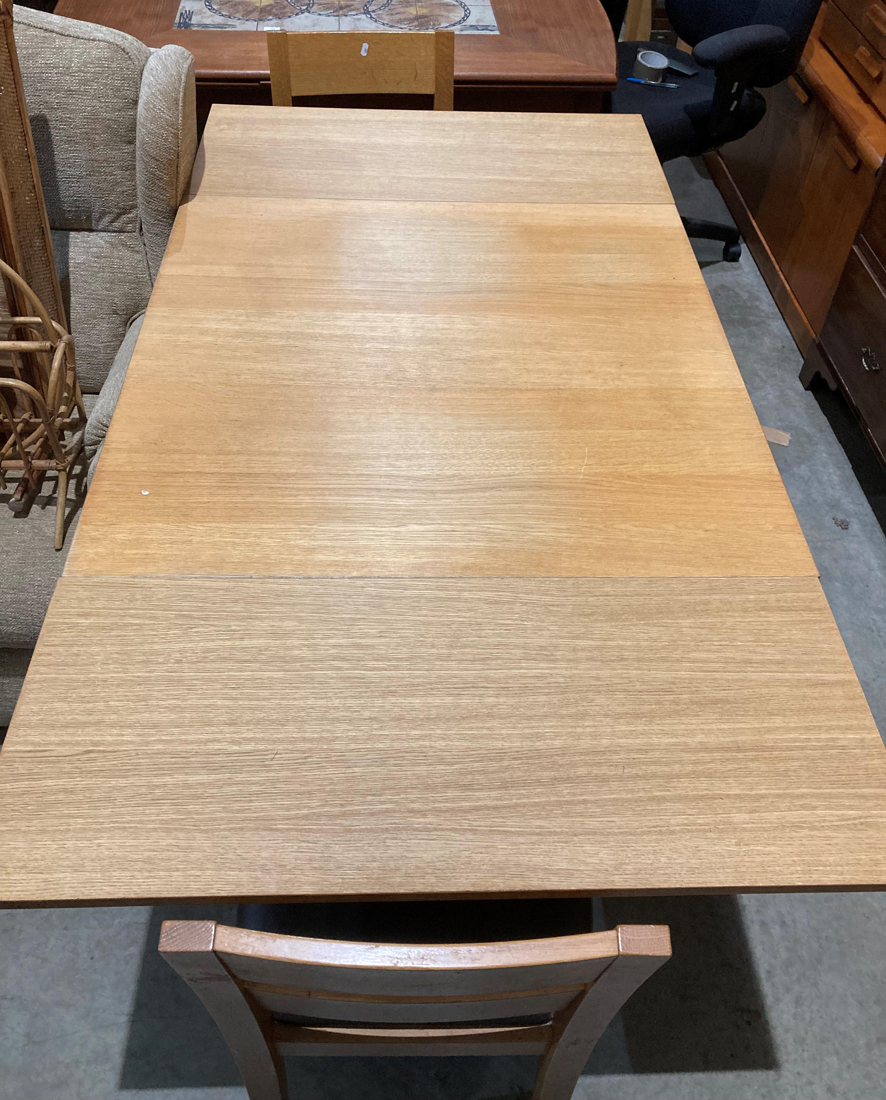 A light oak finish drop-leaf dining table (90 x 90-166cm) with two light oak dining chairs