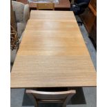 A light oak finish drop-leaf dining table (90 x 90-166cm) with two light oak dining chairs