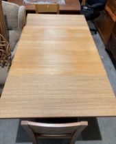 A light oak finish drop-leaf dining table (90 x 90-166cm) with two light oak dining chairs