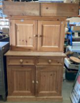 A pine two door, two drawer base unit (99 x 87cm high),