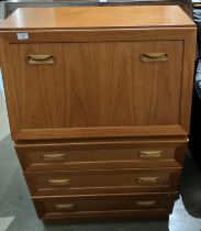 A G-Plan teak finish bureau with fall flap and three drawers,