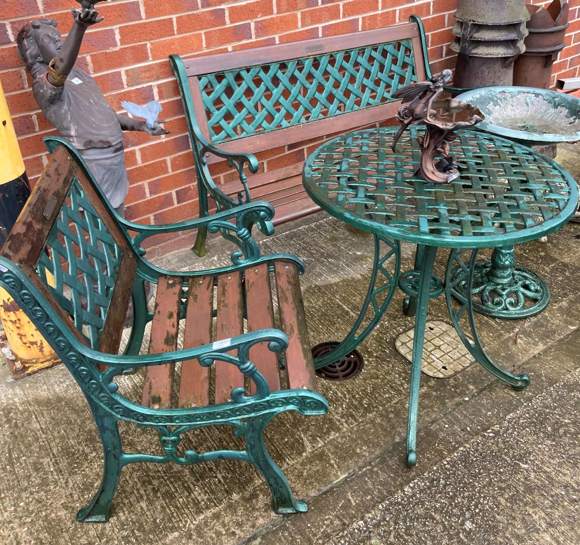 A green metal three-piece garden set comprising bench with wooden slats (130cm),