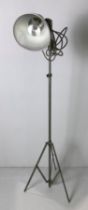 A metal adjustable floor lamp with aluminium shade and tripod base,