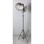 A metal adjustable floor lamp with aluminium shade and tripod base,