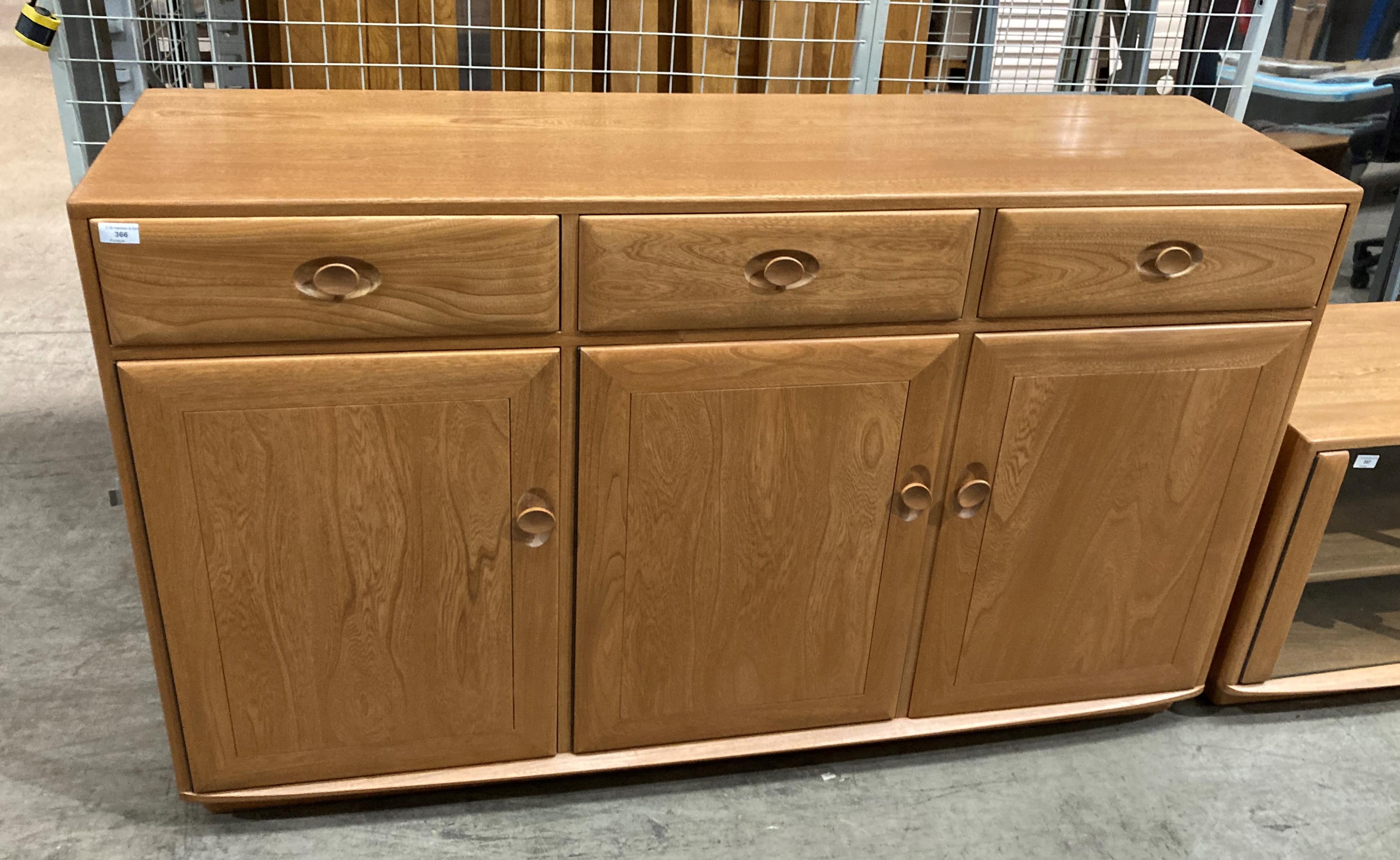 An Ercol blond elm three-drawer, three-door sideboard,