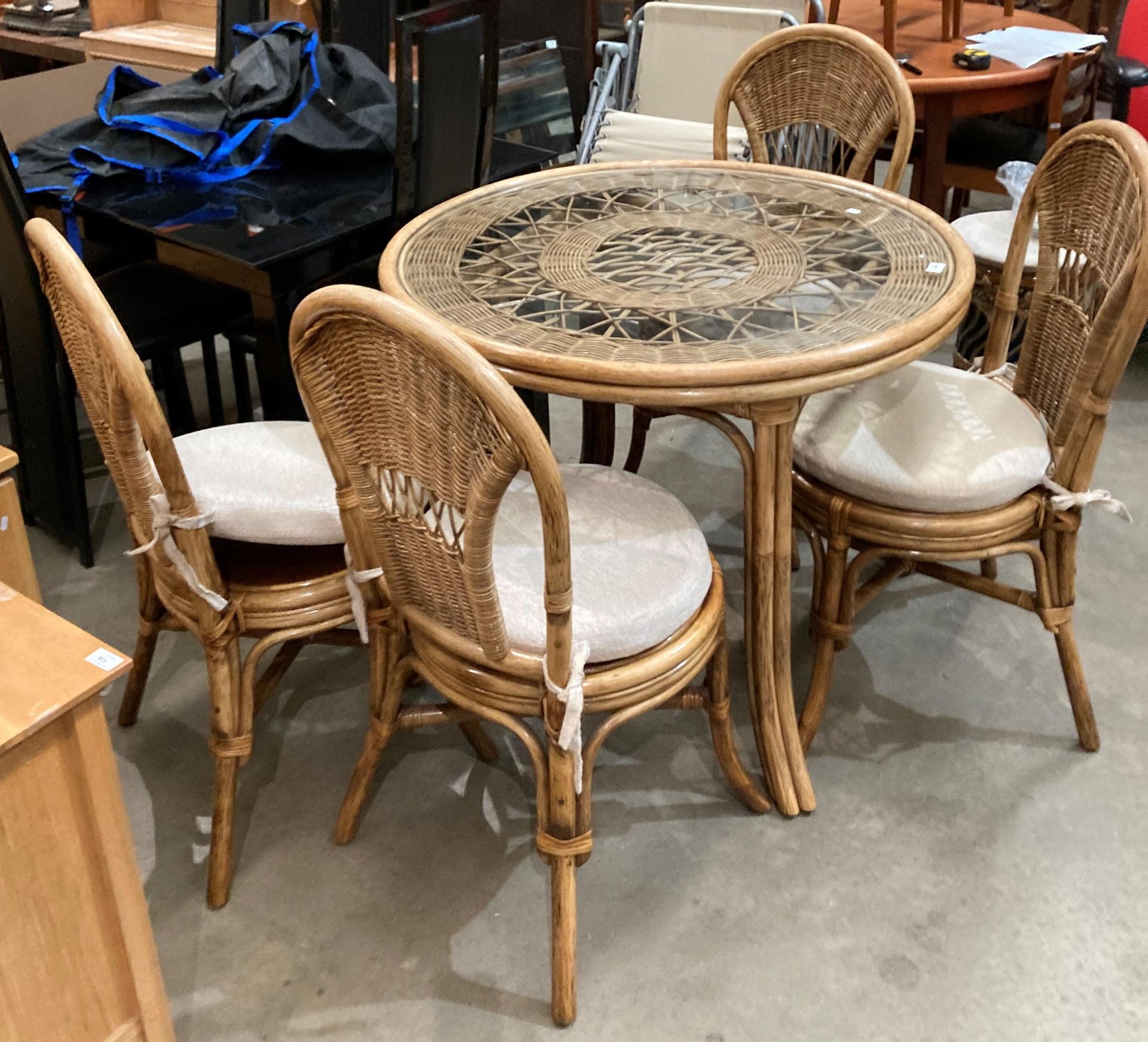 A bamboo framed conservatory suite with glass top circular table (97cm diameter) and four chairs