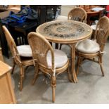 A bamboo framed conservatory suite with glass top circular table (97cm diameter) and four chairs