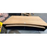 A light oak and black melamine low shaped entertainment stand with two undershelves,