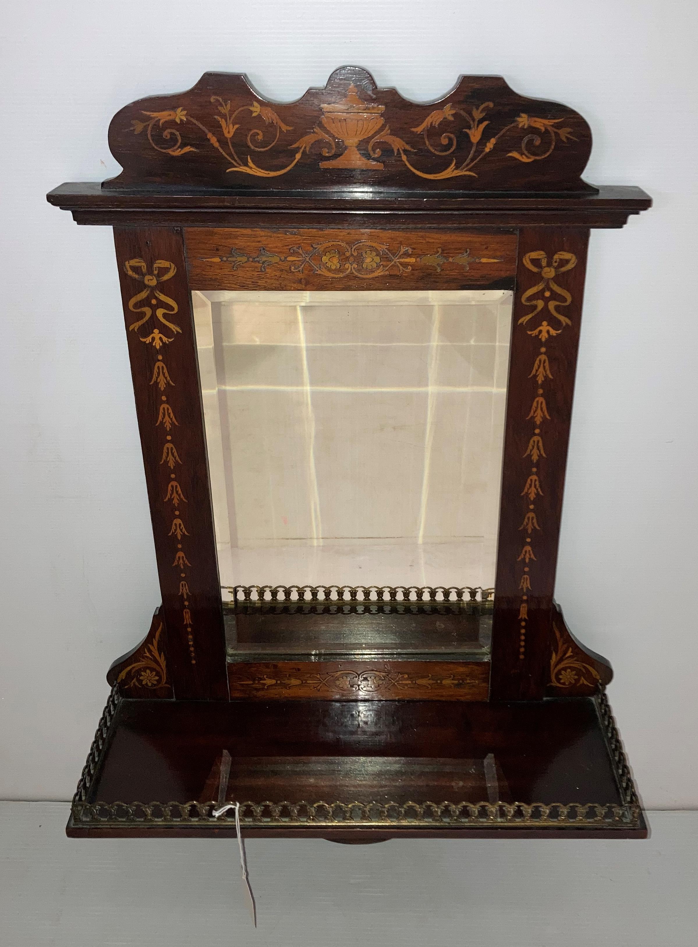 A mahogany wall mirror with single-shelf,