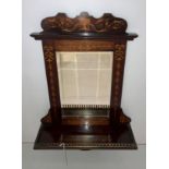 A mahogany wall mirror with single-shelf,