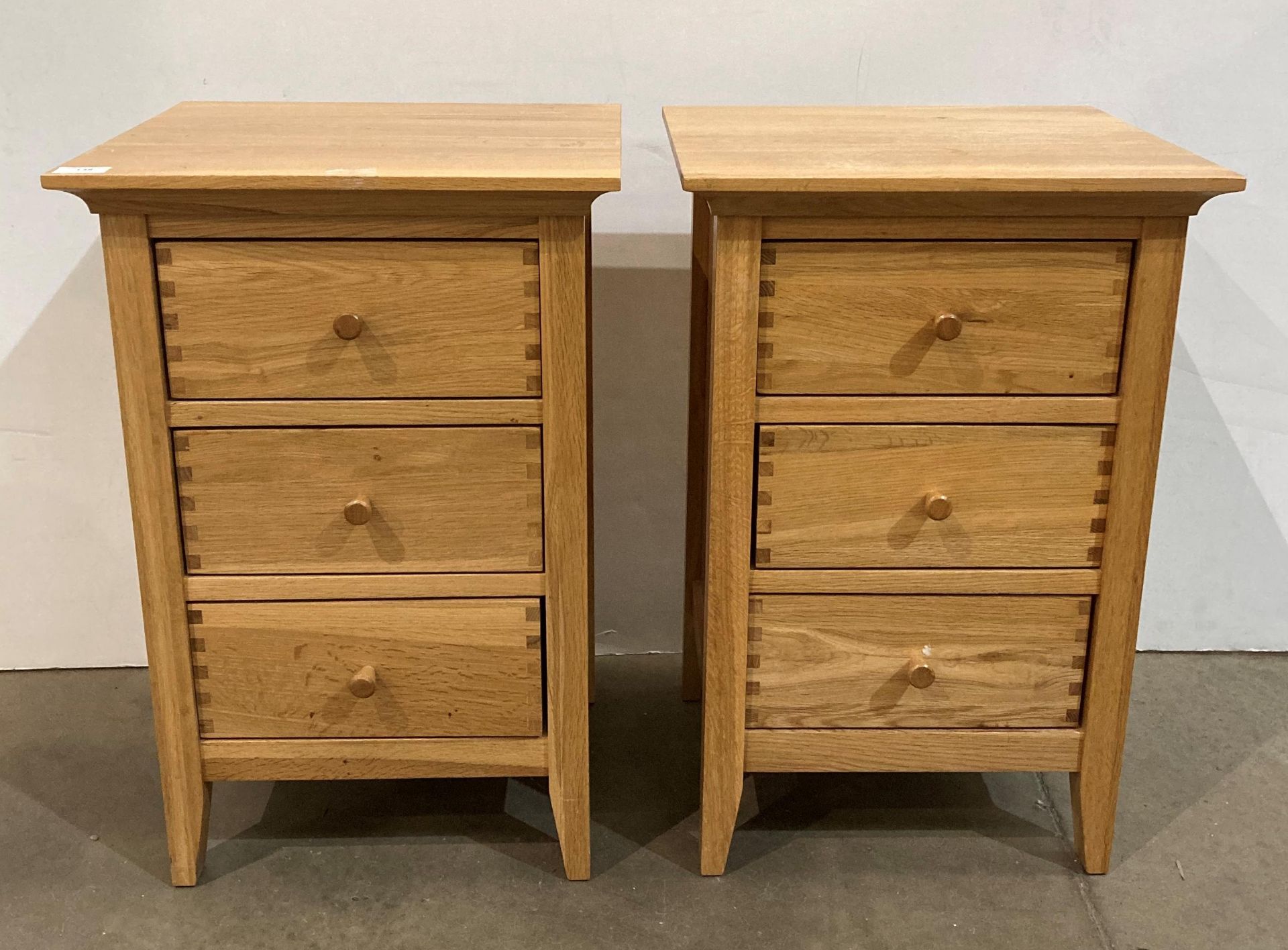 Two Willis & Gambier oak three drawer bedside cabinet,