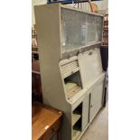 A grey painted wood kitchen utility cabinet,