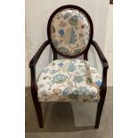 A vintage-style Stuart Jones round-back open-elbow armchair in a dark mahogany frame and floral