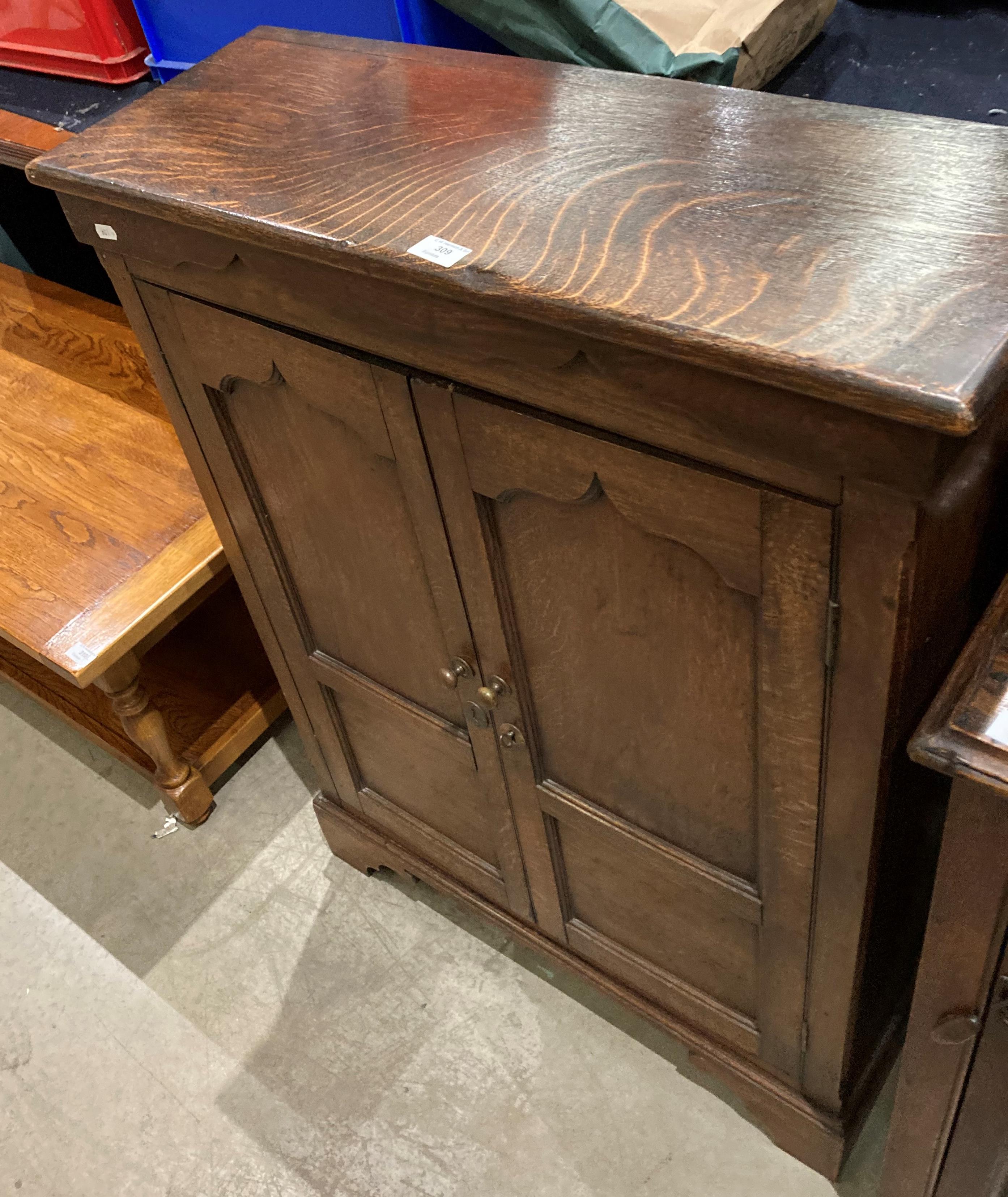 An oak two door storage cupboard,