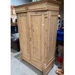 A pine two-door wardrobe - converted internally into a storage cupboard,