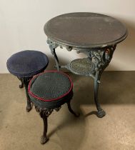 A vintage cast iron pub table with copper covered top and under-shelf with inscription reading